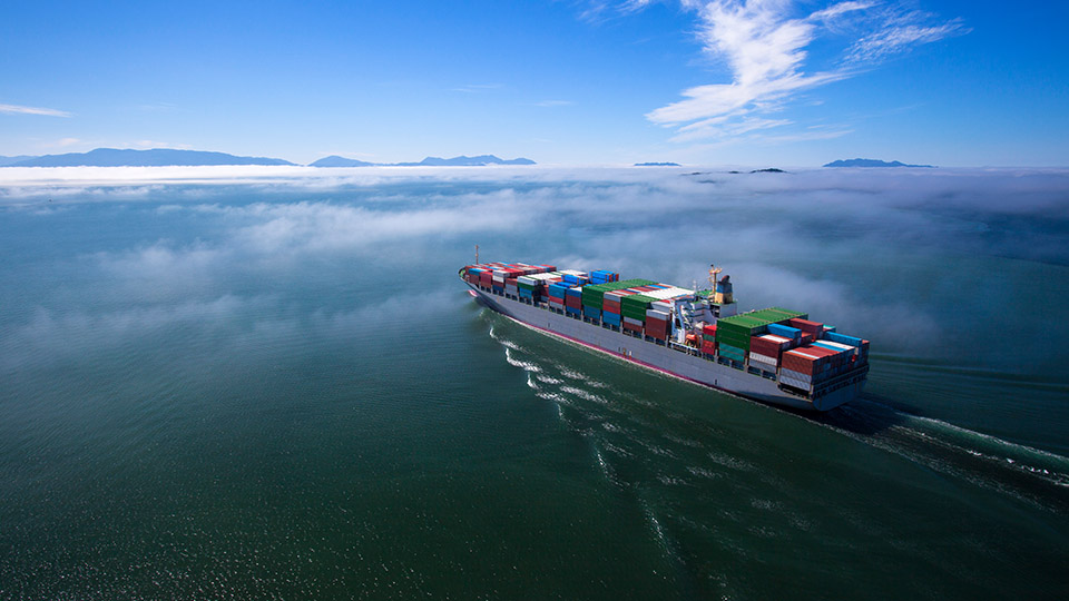 Container ship in the mist at sea