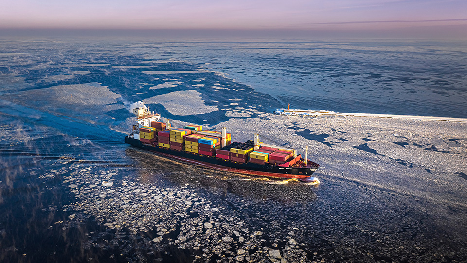 A container ship navigating through icy waters-
