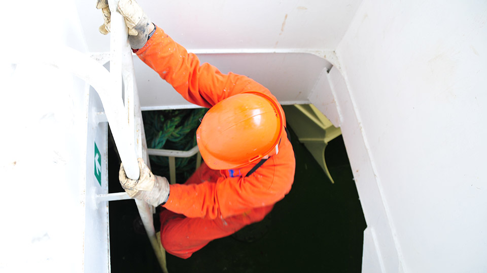 seafarer emerging from ship's hatch