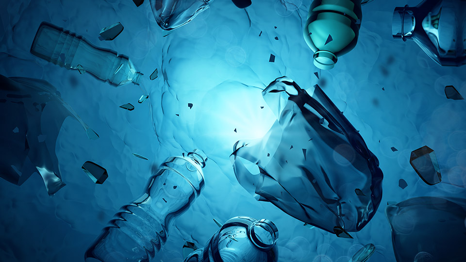 underwater view of plastic bottles and bags floating