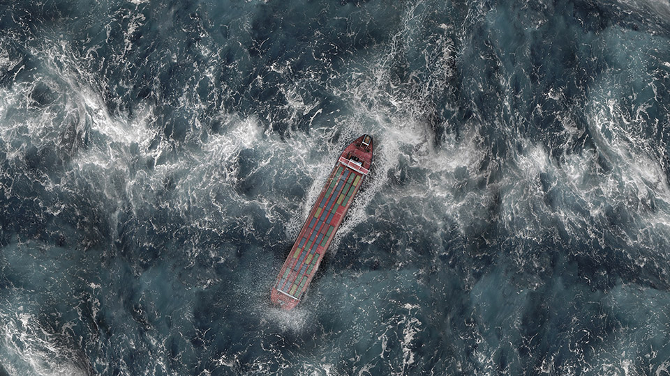 Aerial view of container ship in stormy ocean