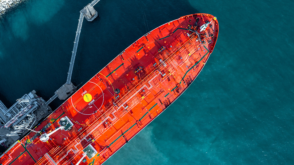 Aerial view of red crude oil tanker ship at port