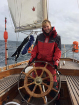 Camilla Vestergaard at the wheel of a yacht