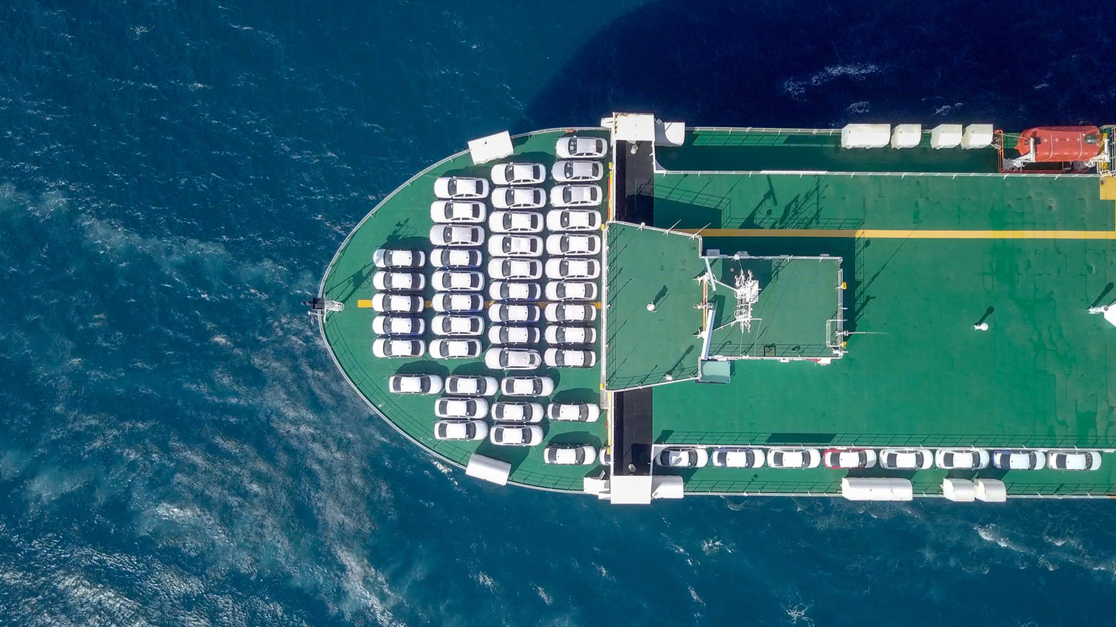 Vehicles being transported on the deck of a ship