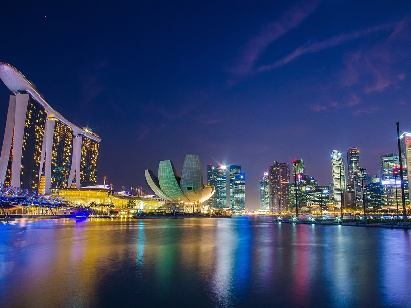 VIew of Singapore at night with Marina Bay Sands hotel in background
