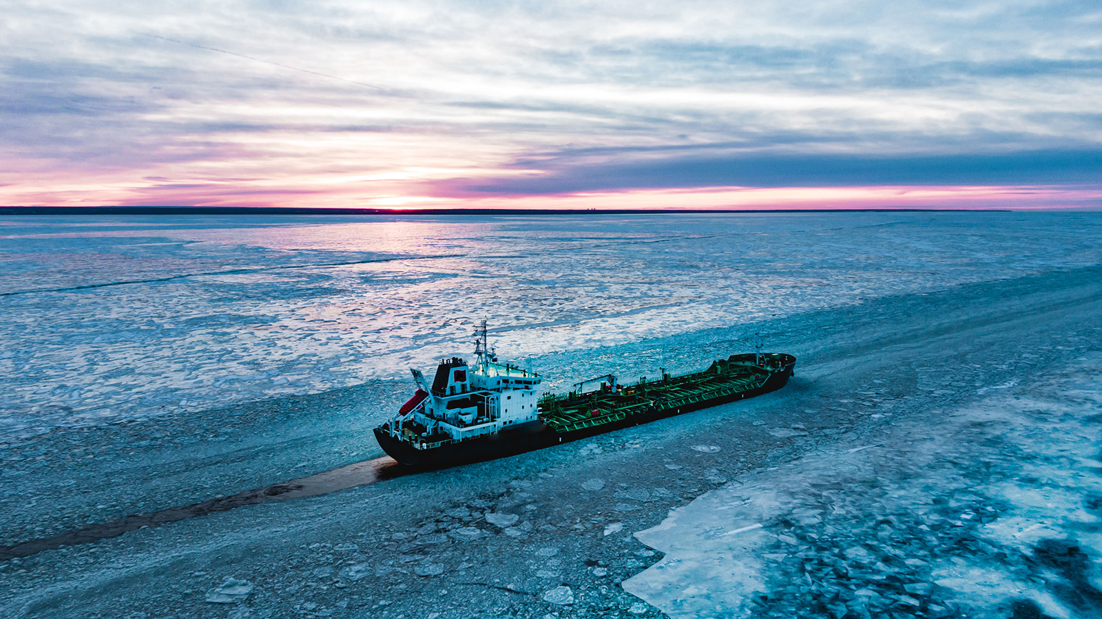 oil tanker navigating icy waters at sunset