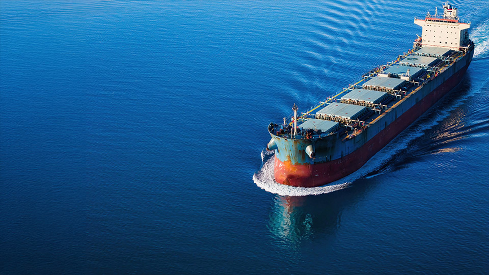 Bulk carrier ship at sea seen from above and to the side