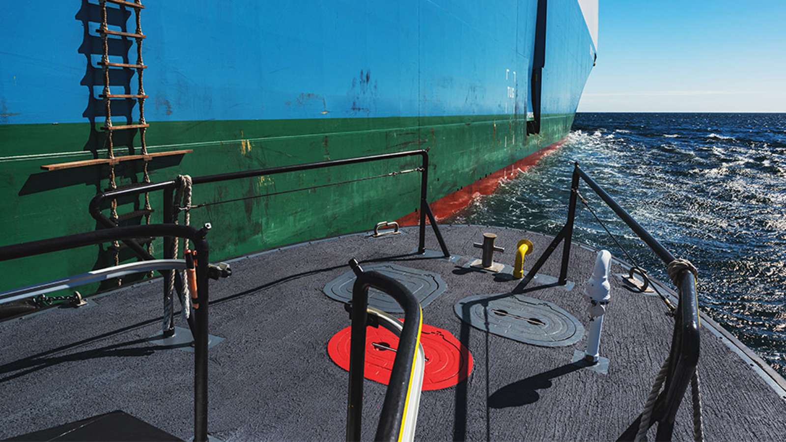 Pilot boat alongside a ship showing ladder on the side of ship
