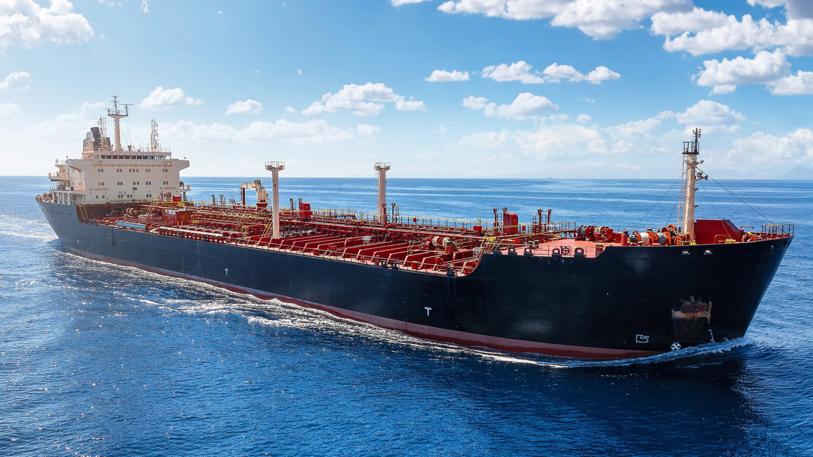 red & black tanker ship at sea